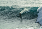 Matthew doing a carve on a big wave whilst ridinga diamond tail single fin.