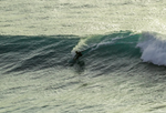 Matthew doing a grab rail cutback on a big wave whilst riding a diamond tail single fin.