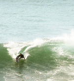 Matthew doing a grab rail cut back manoeuvre turn on a step up surfboard. 