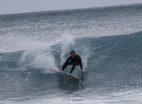 Matthew doing a grab rail cutback on a mini egg surfboard.