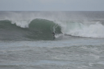 Matthew surfing a step up model surfboard at a point break in big swell.