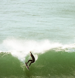 Matthew doing a layback manoeuvre on a Step up model surfboard.