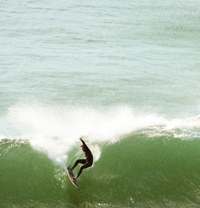 Matthew doing a layback manoeuvre on a Step up model surfboard.