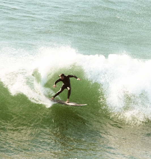 Matthew doing a carve manoeuvre on step up model surfboard.